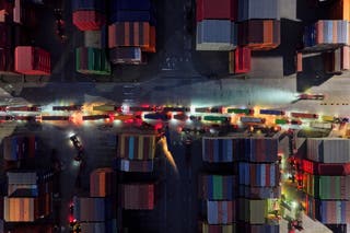Trucks line up to depart from a container terminal in Nanjing in east China's Jiangsu province