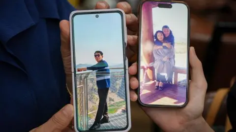 BBC/Hosu Lee Two phones, held in hands, show still images of an older man, one of them with his arms round a woman.